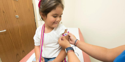 Girl happy after getting vaccinated (CC0 CDC)