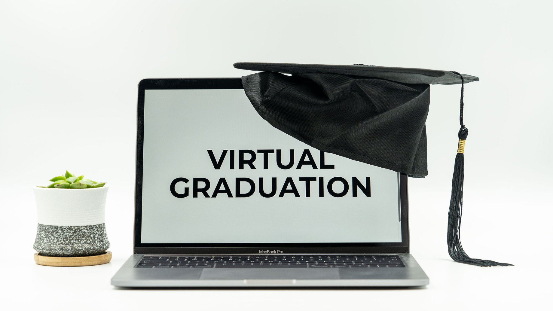 Graduation hat on laptop for virtual graduation