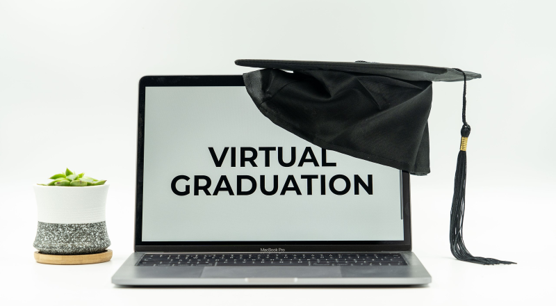 Graduation hat on laptop for virtual graduation